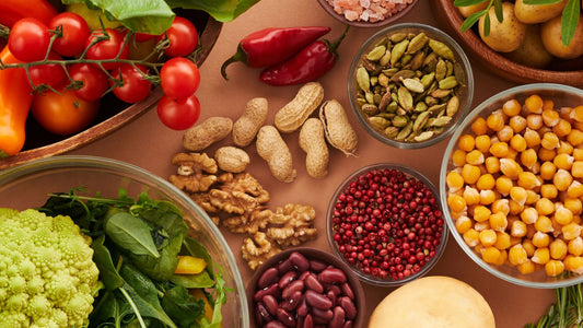 Vegetables, beans, nuts and spices arranged on a table.