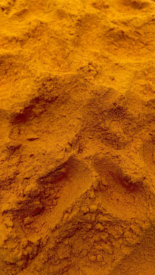Close-up texture of orange turmeric powder.